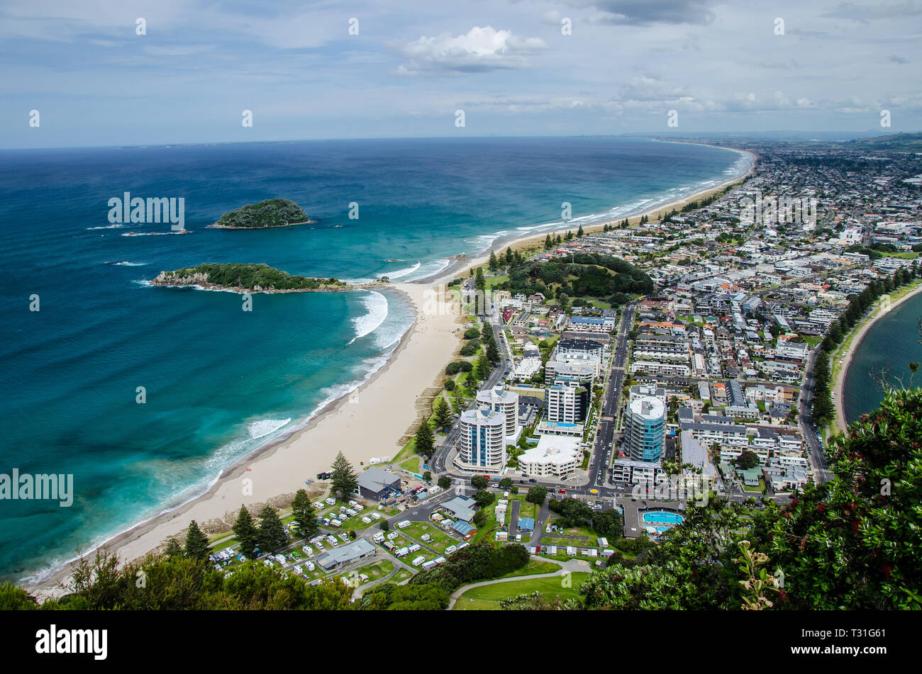 View of the coastline from the top of Mount Manganui with blue sky above, Tauranga, North Island, New Zealand. Stock Photo