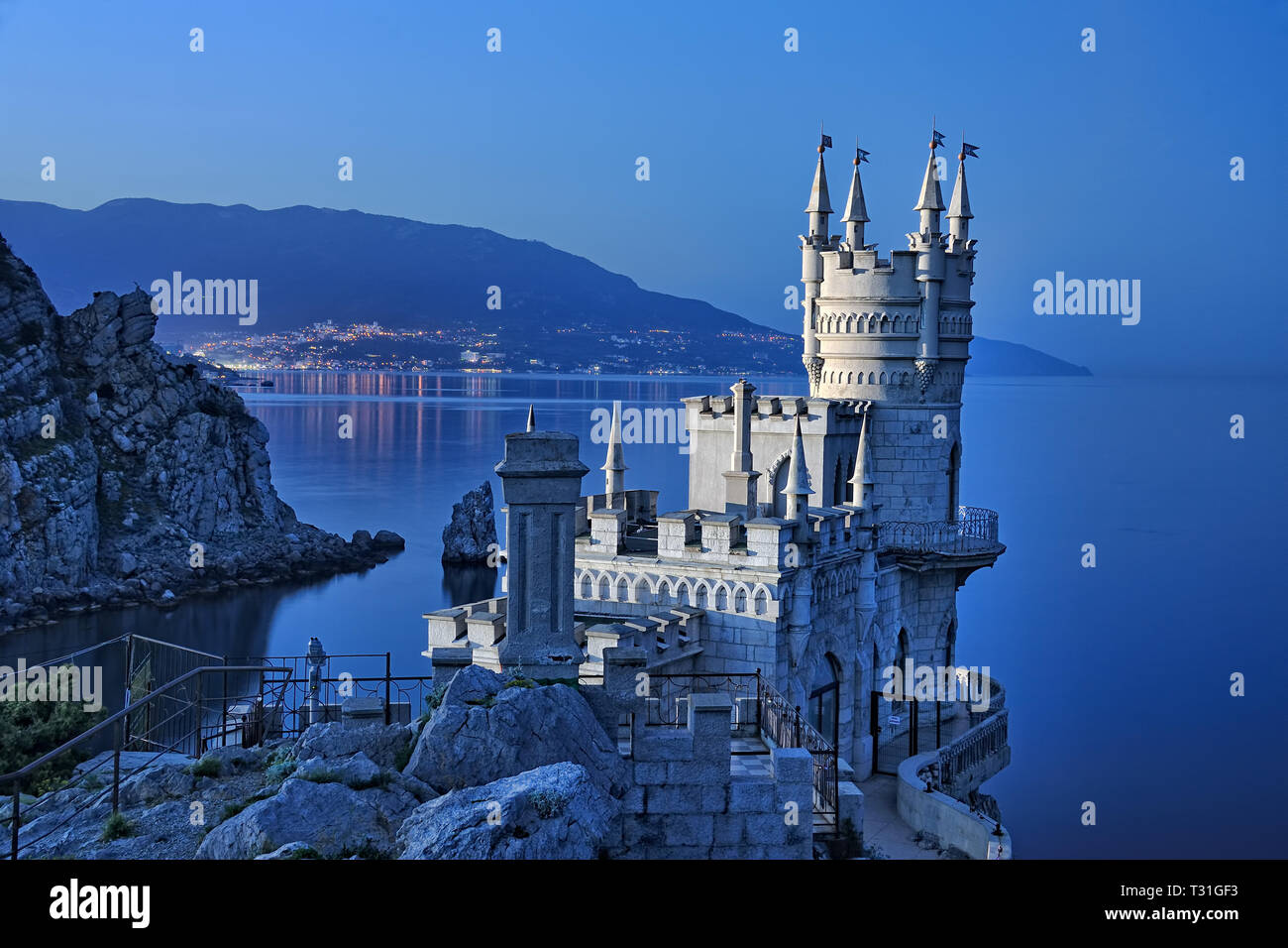= Fairytale Swallow's Nest Castle and Yalta Bay in Twilight =  Beautiful view from a top of Aurora Cliff of Ai-Todor Cape in Gaspra on the Neo-Gothic  Stock Photo