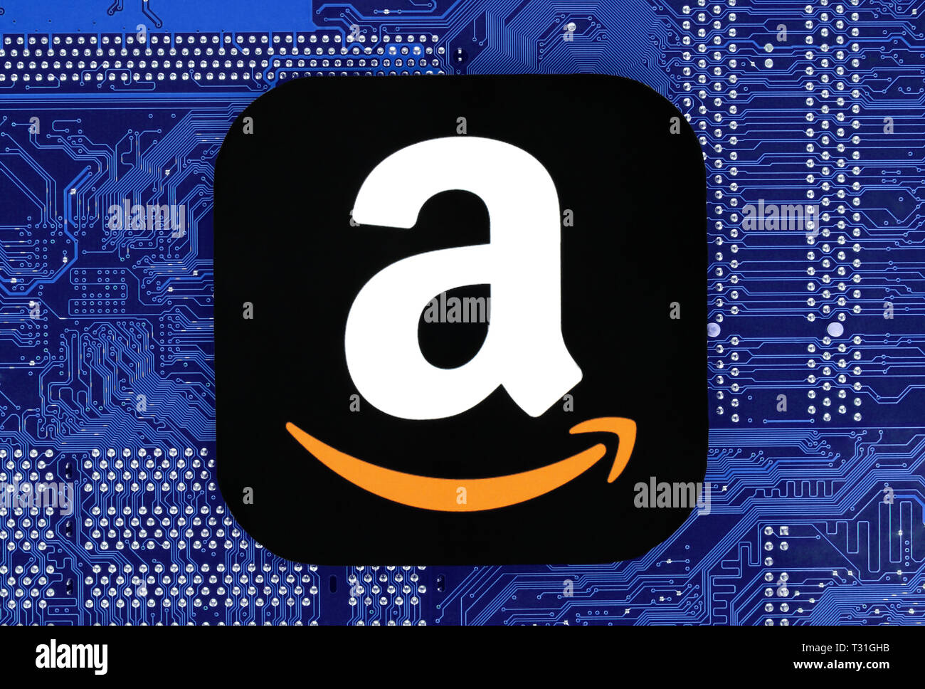 Kiev, Ukraine - February 12, 2019: Amazon icon printed on paper and placed on circuit board Stock Photo
