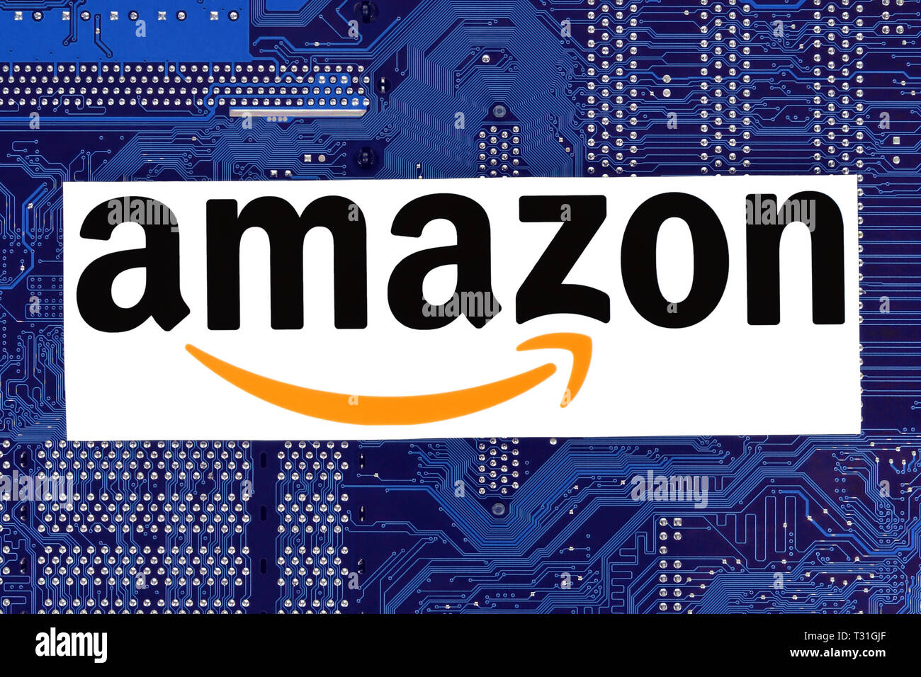 Kiev, Ukraine - February 12, 2019: Amazon logo printed on paper and placed on circuit board Stock Photo