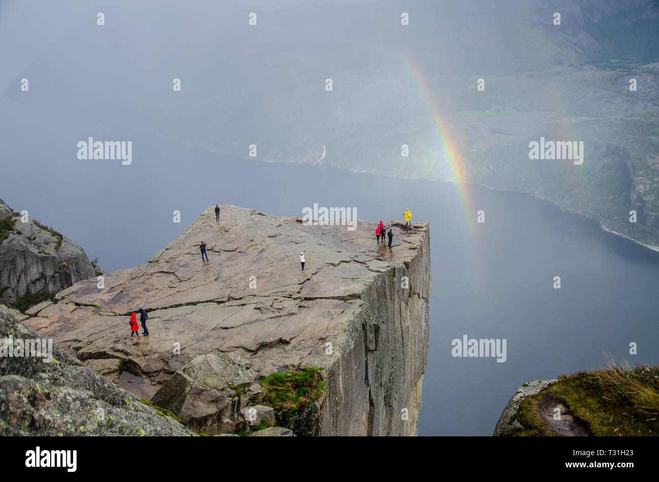 Preikestolen Pulpit Rock with double rainbow in the background a Lysefjord underneath. Stock Photo