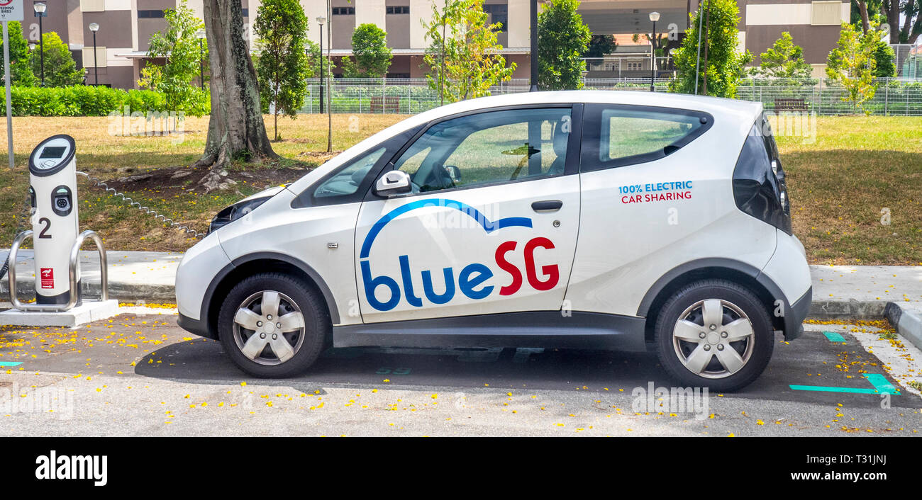 Blue SG Bolloré Bluecar, electric car charging at an electric vehicle recharching station in Singapore. Stock Photo