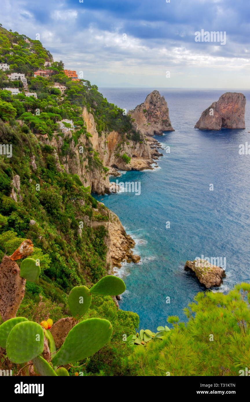 Sea view by Capri island, Italy. The rocks are famous as Faraglioni rock. Locals say that they have seen sirens on this rock and often hear their whis Stock Photo