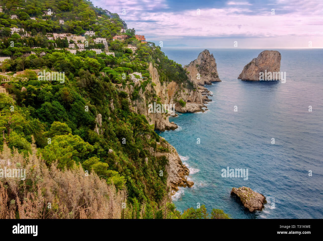 Sea view by Capri island, Italy. The rocks are famous as Faraglioni rock. Locals say that they have seen sirens on this rock and often hear their whis Stock Photo