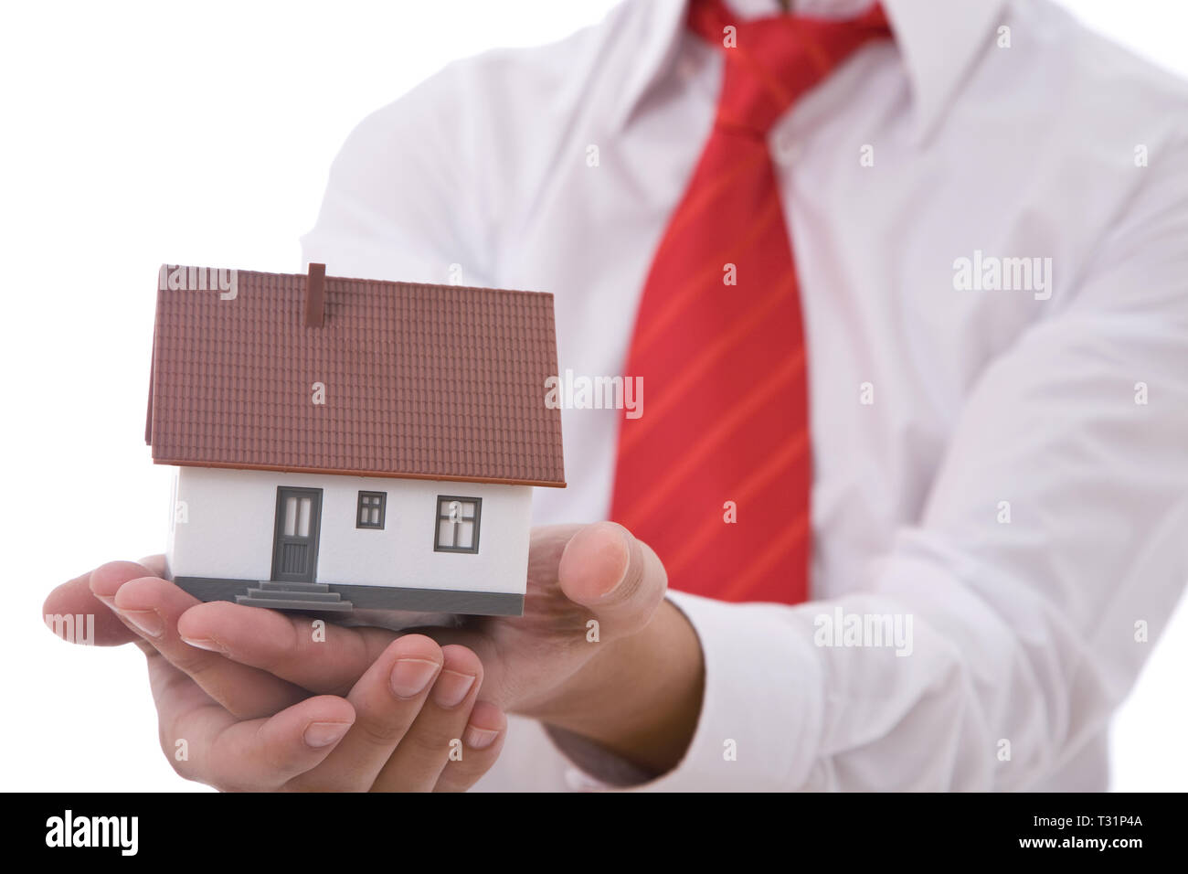 real estate concept with a businessman holding a mini house Stock Photo ...