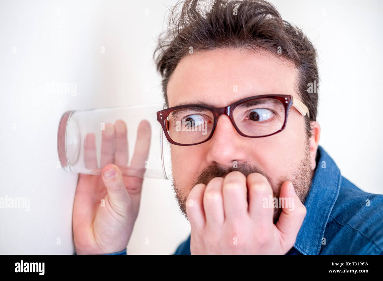 Spying glass to wall hires stock photography and images Alamy