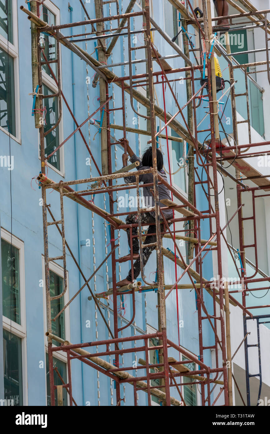 a scaffolder working at height without any protection or safety harness