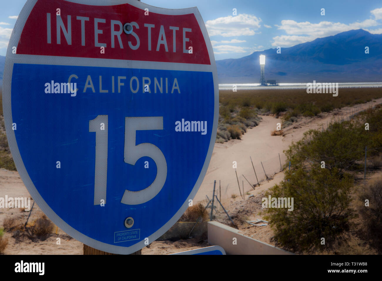 A california interstate sign in the mojave desert with a Solar tower in the background. Stock Photo