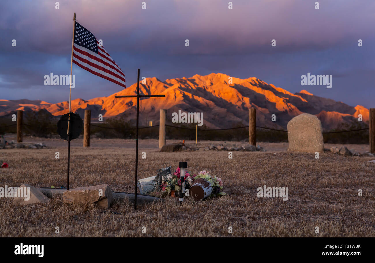 A desert grave in the mojave with an American flag, California. Stock Photo