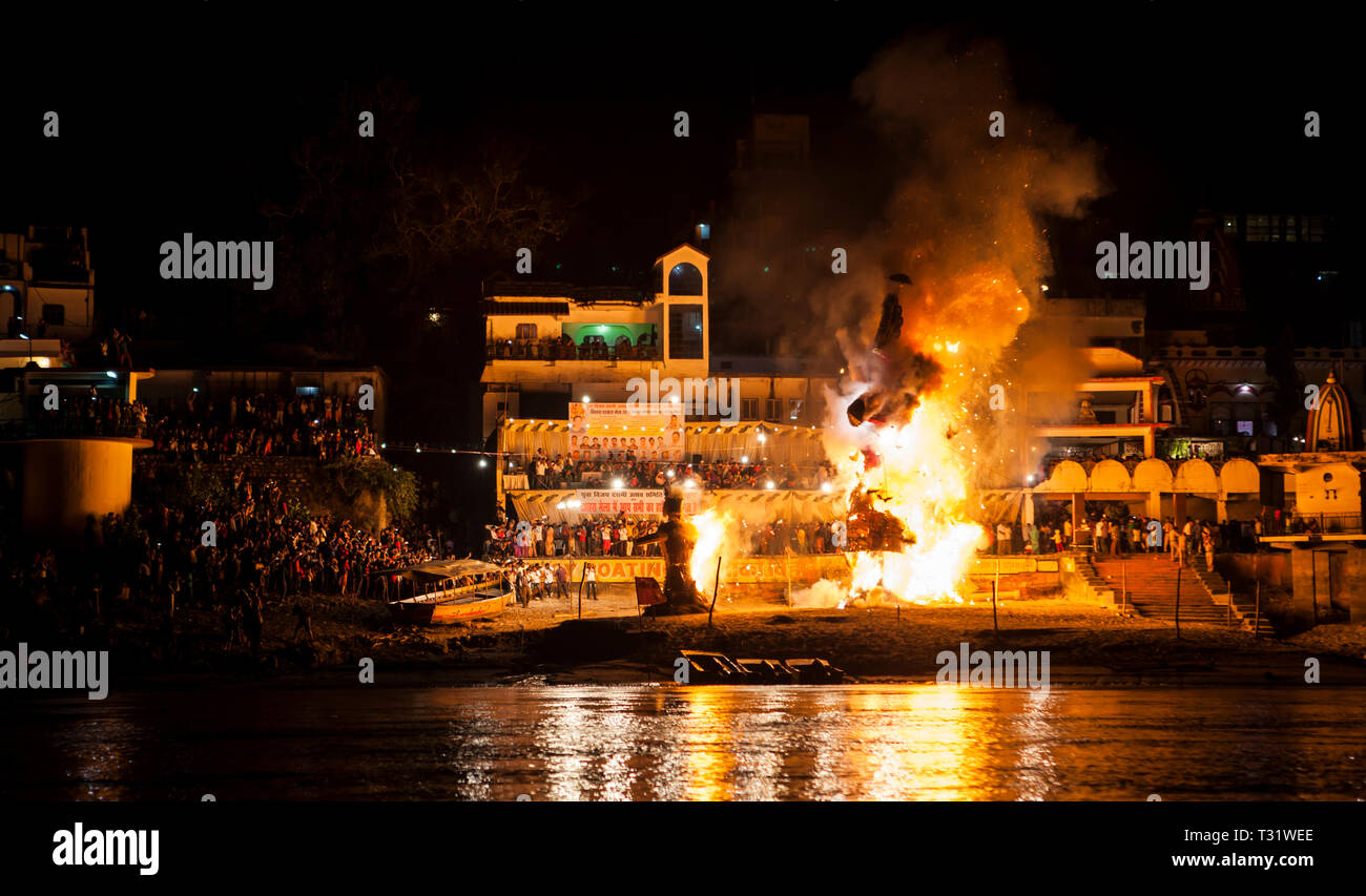 Crowd watchs burning holy effigy in Rishikesh at night during Purnima Festival Stock Photo