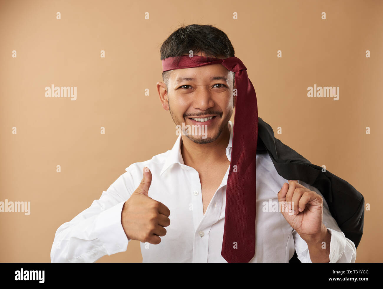 Happy drunk asian guy portrait isolated on brown background Stock Photo ...
