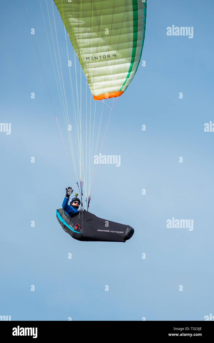 Man paragliding over Hunstanton cliffs on North Norfolk coast, East Anglia, England, UK. Stock Photo
