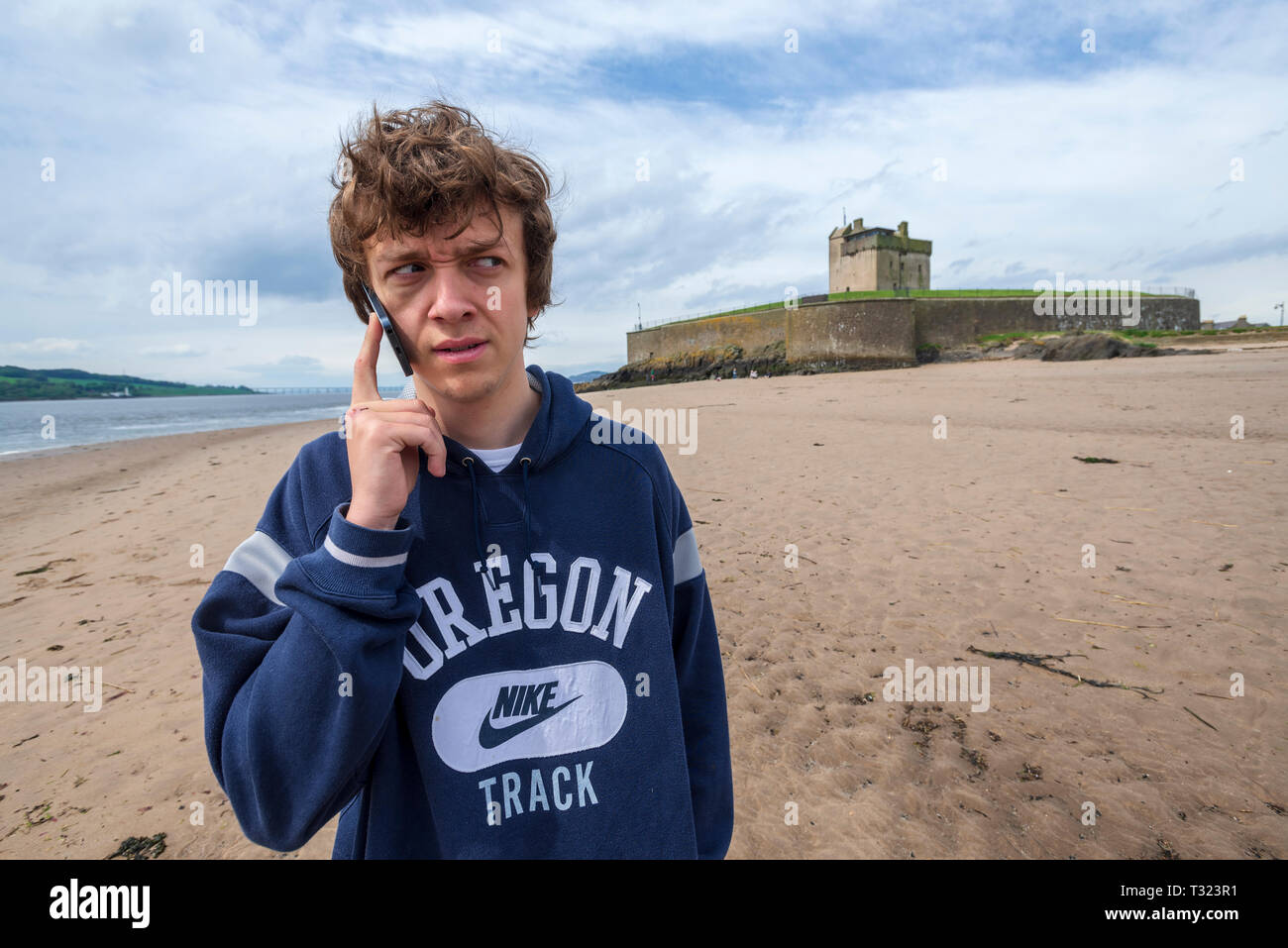 Youth talking on mobile phone. Stock Photo