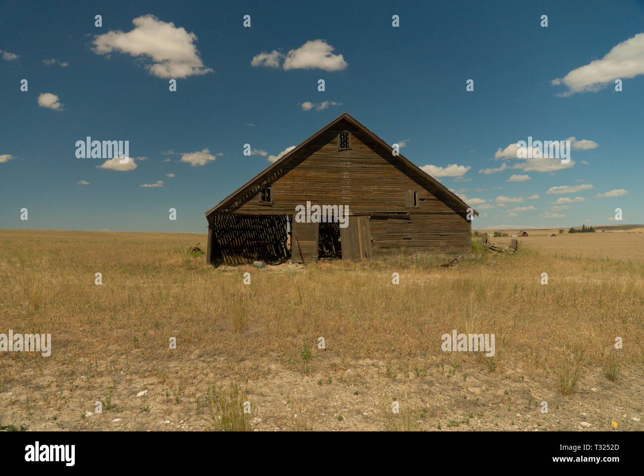 A Weathered Old Barn Stands Alone Against the Harsh Dry Climate Stock Photo