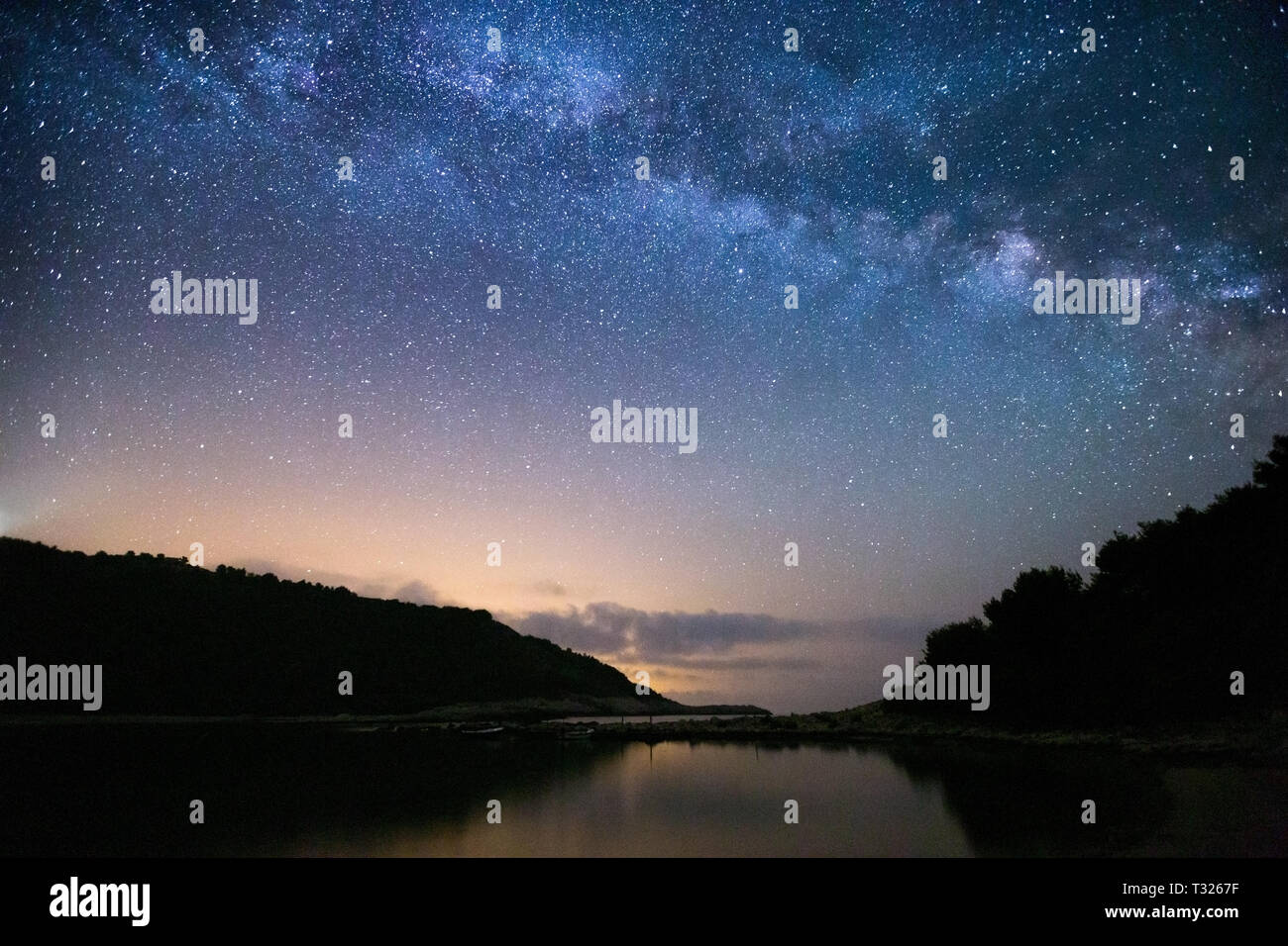 Milky Way over Blace cove. Starry sky. Night sea landscape. Island Mljet, Adriatic sea. Croatia. Europe. Stock Photo