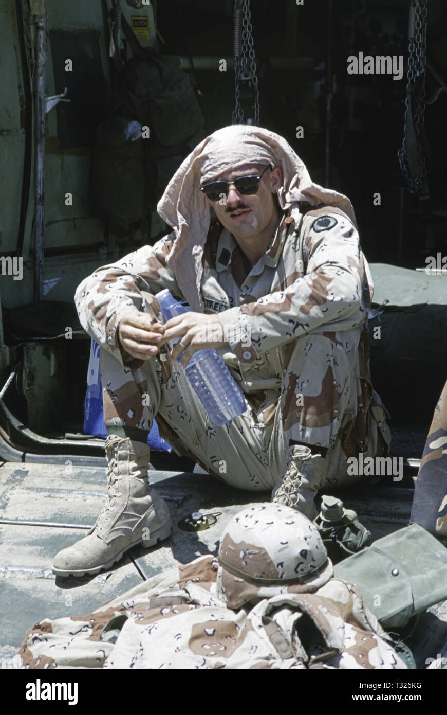 30th October 1993 A U.S. Army soldier of the 24th Infantry Division, named Street, sits at the rear of his M113A3 ambulance (a variant of a United Defense M113 APC). He has just arrived by ship in Mogadishu's new port in Somalia. Stock Photo