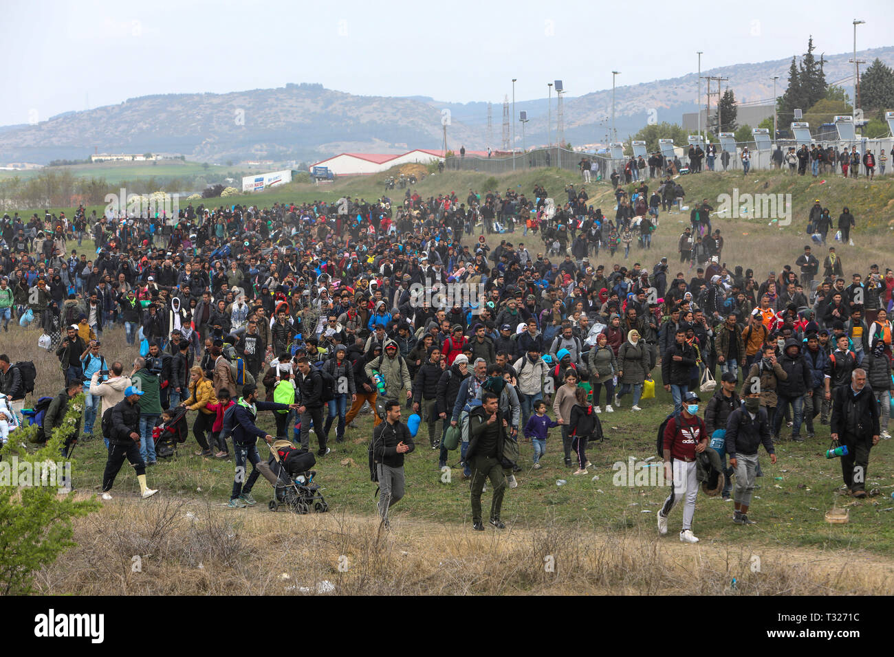 Thessaloniki, Greece - April 5, 2019: Hundreds of migrants and refugees gathered outside of a refugee camp in Diavata to walk until the Northern borde Stock Photo