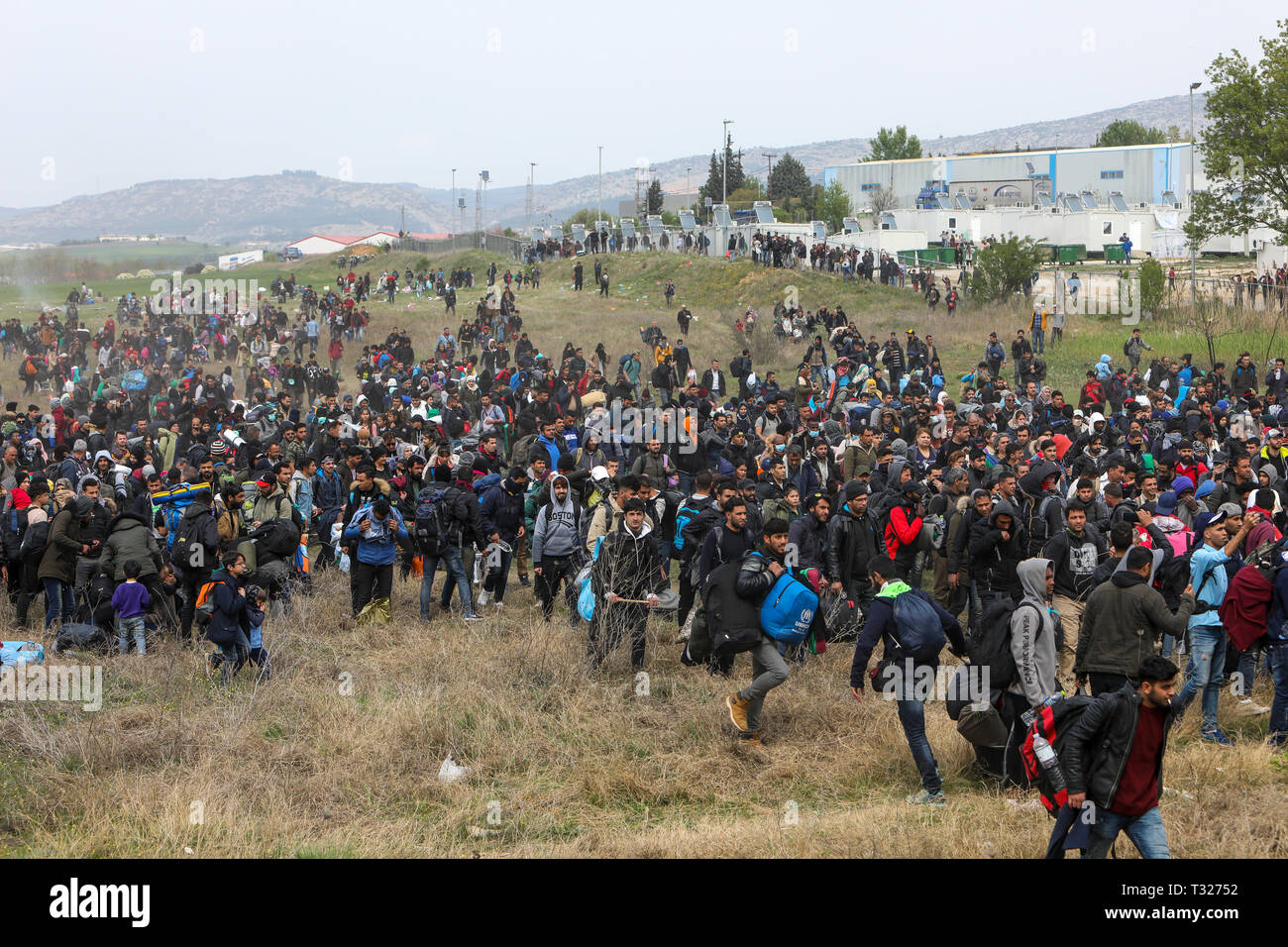 Thessaloniki, Greece - April 5, 2019: Hundreds of migrants and refugees gathered outside of a refugee camp in Diavata to walk until the Northern borde Stock Photo