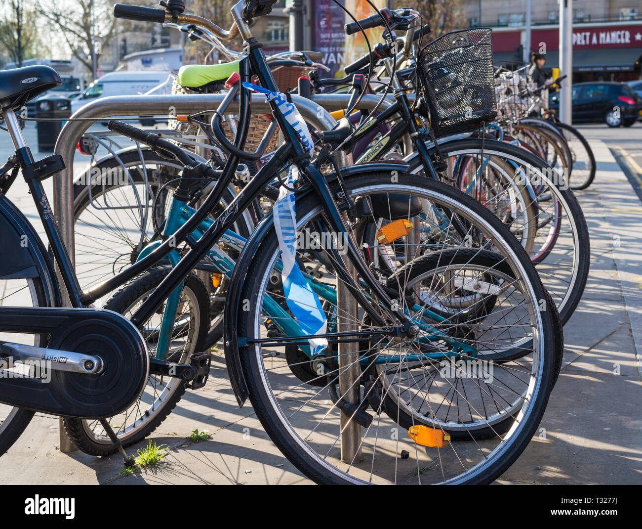 Line of bicycles in a bike rack on a busy London street. Stock Photo