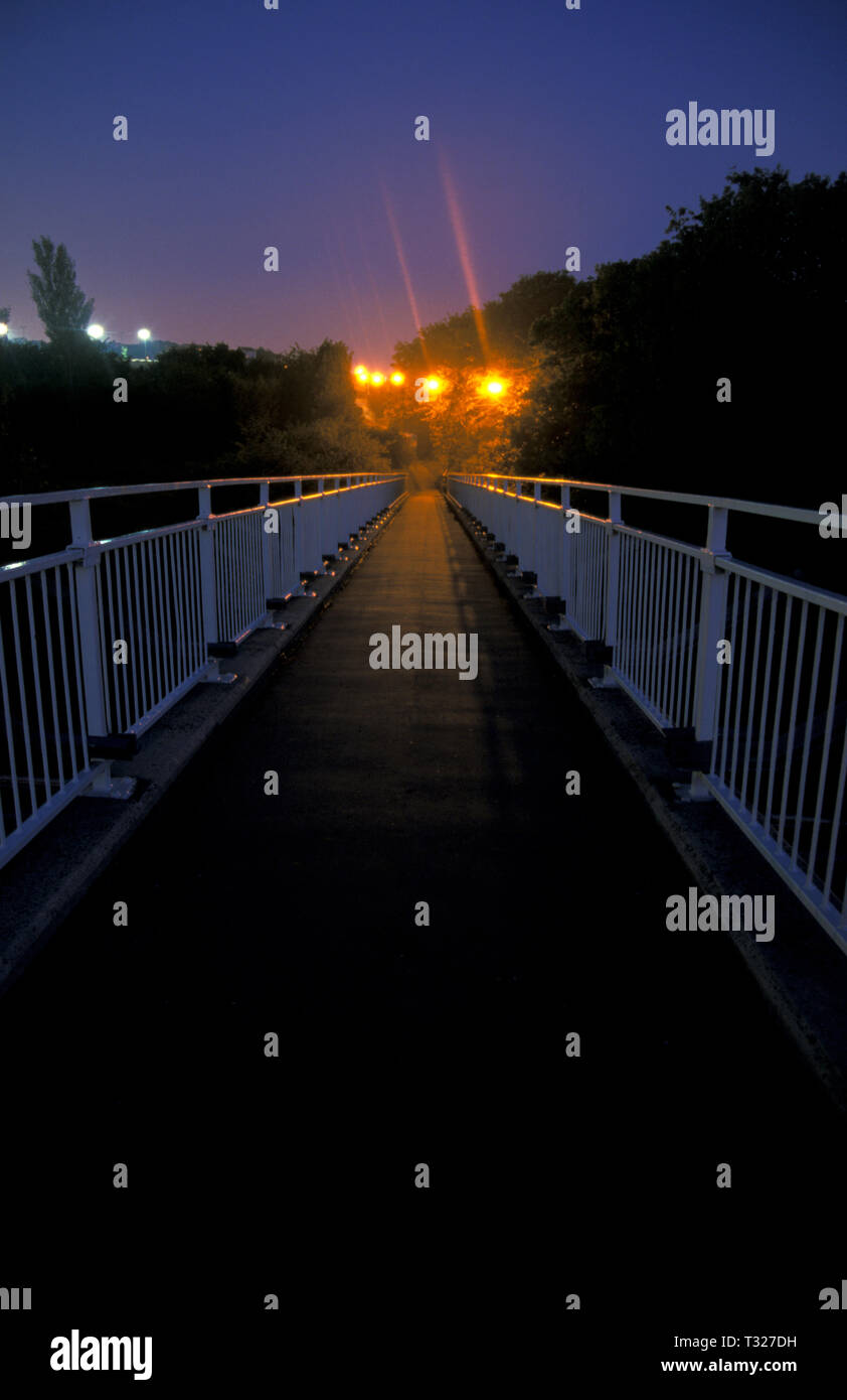dark and eerie floodlit footbridge Stock Photo