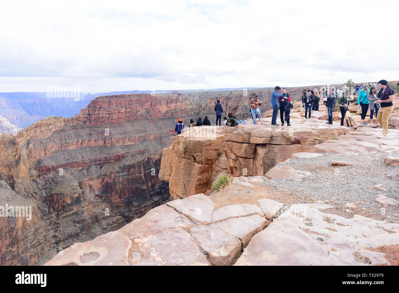 GRAND CANYON - February 19: Tourists take pictures at Eagle Point at Grand Canyon West Rim on February 19, 2017 in Grand Canyon, AZ Stock Photo