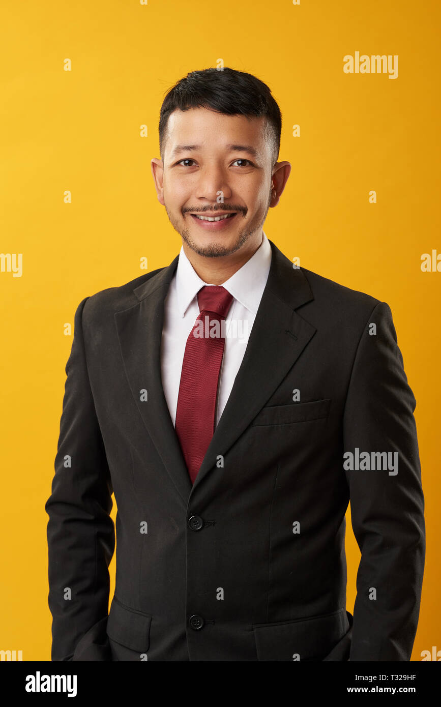 Asian guy portriat on yellow color background. Asian business concept Stock Photo