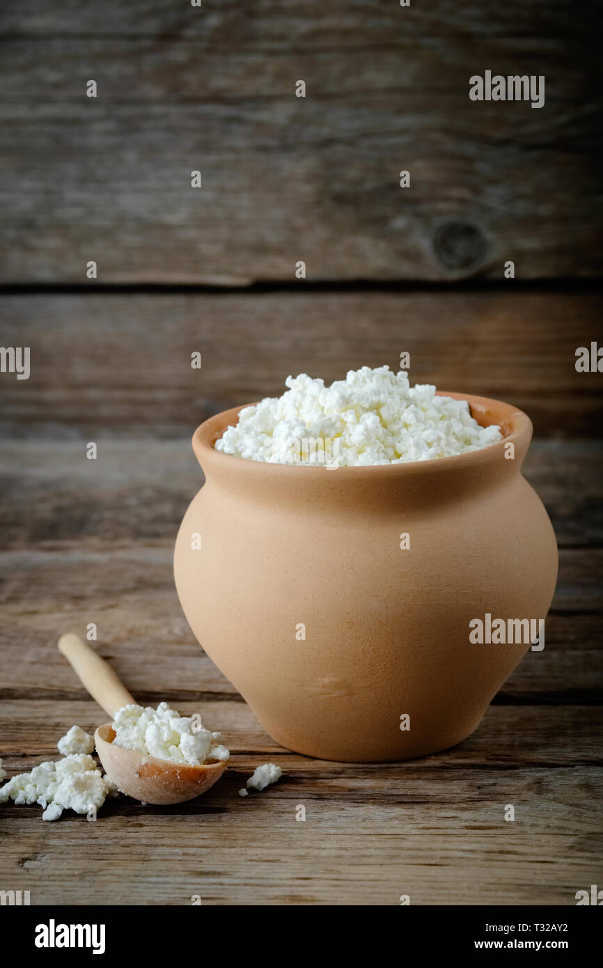 Cottage Cheese In Brown Rustic Clay Pot And Wooden Spoon Stock Photo Alamy