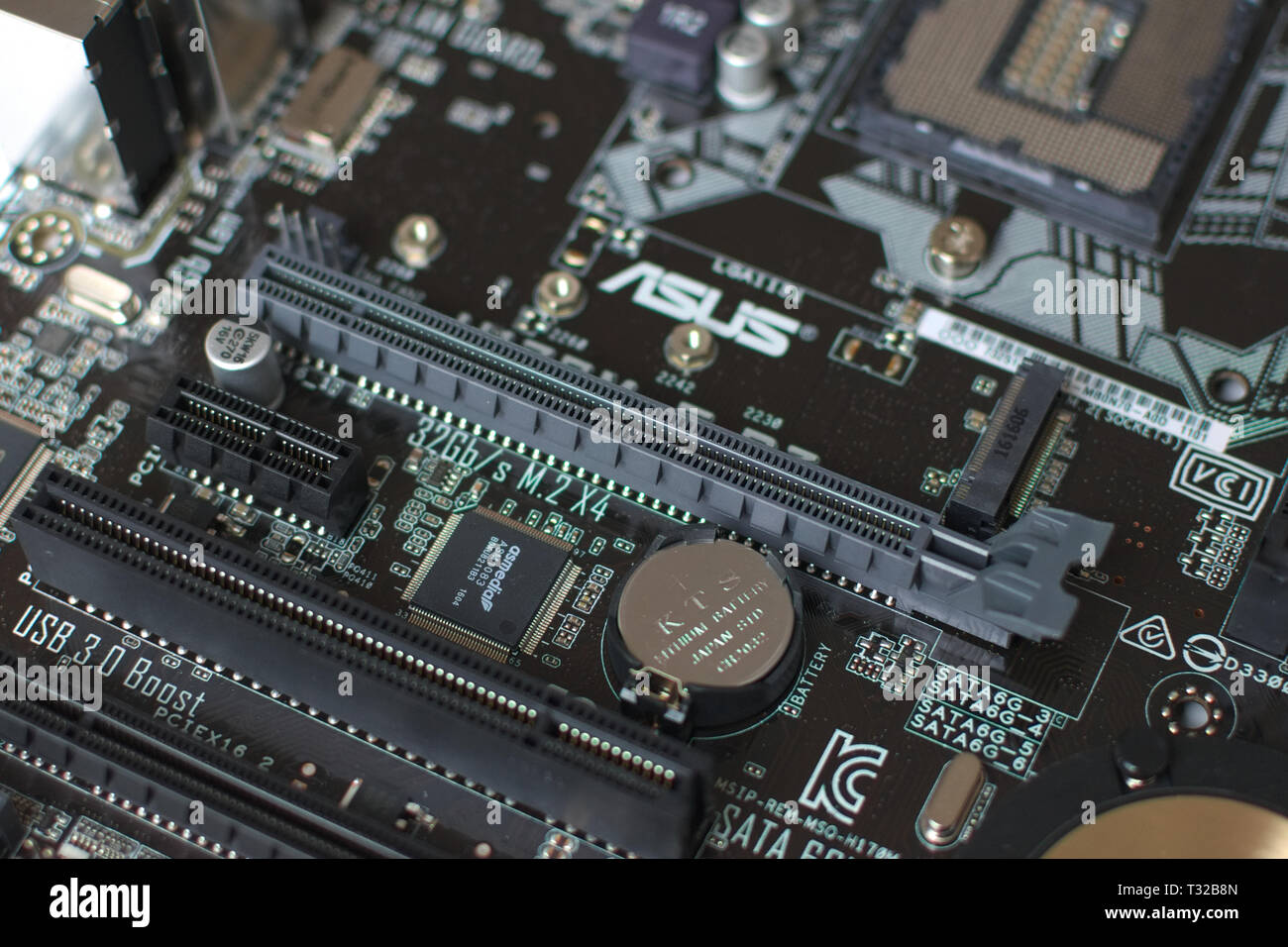 Modern computer ATX format motherboard. Electronic components, sockets and soldering points can be clearly seen. Stock Photo