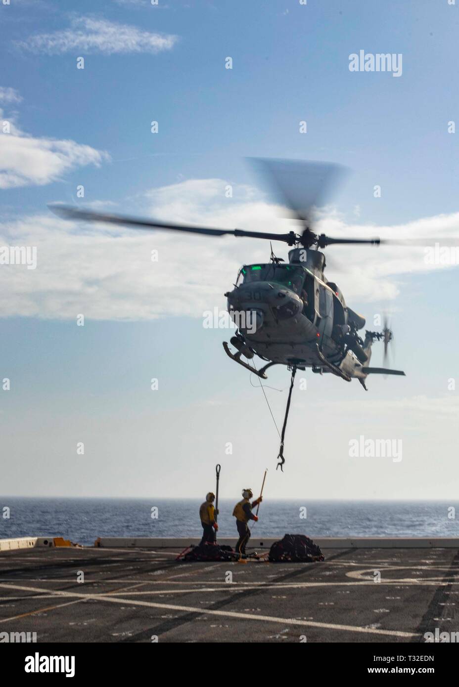 190401-N-HG389-0069 MEDITERRANEAN SEA (April 1, 2019) Sailors practice attaching pallets to a UH-1Y Huey helicopter assigned to the “Black Knights” of Marine Medium Tiltrotor Squadron (VMM) 264 (Reinforced) aboard the San Antonio-class amphibious transport dock ship USS Arlington (LPD 24), April 1, 2019. Arlington is on a scheduled deployment as part of the Kearsarge Amphibious Ready Group in support of maritime security operations, crisis response and theater security cooperation, while also providing a forward naval presence. (U.S. Navy photo by Mass Communication Specialist 2nd Class Brando Stock Photo