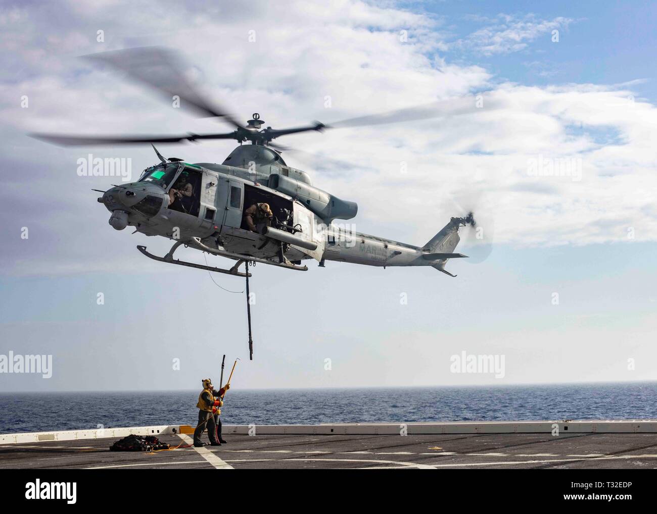 190401-N-HG389-0076 MEDITERRANEAN SEA (April 1, 2019) Sailors practice attaching pallets to a UH-1Y Huey helicopter assigned to the “Black Knights” of Marine Medium Tiltrotor Squadron (VMM) 264 (Reinforced) aboard the San Antonio-class amphibious transport dock ship USS Arlington (LPD 24), April 1, 2019. Arlington is on a scheduled deployment as part of the Kearsarge Amphibious Ready Group in support of maritime security operations, crisis response and theater security cooperation, while also providing a forward naval presence. (U.S. Navy photo by Mass Communication Specialist 2nd Class Brando Stock Photo