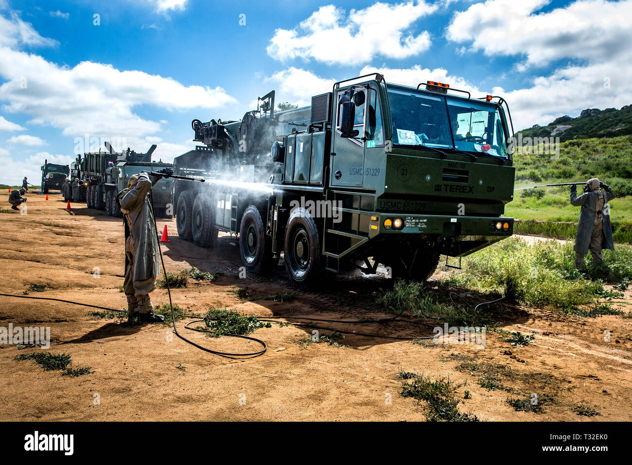 U.S. Marines with 7th Engineer Support Battalion (7th ESB), 1st Marine Logistics Group, give vehicles a final rinse during a decontamination exercise at Marine Corps Base Camp Pendleton, California, April 2, 2019. 7th ESB conducted the exercise to sharpen the Marine’s skills decontaminating tactical vehicles that are exposed to chemical, biological, radiological and nuclear contaminants. (U.S. Marine Corps photo by Lance Cpl. Betzabeth Y. Galvan) Stock Photo