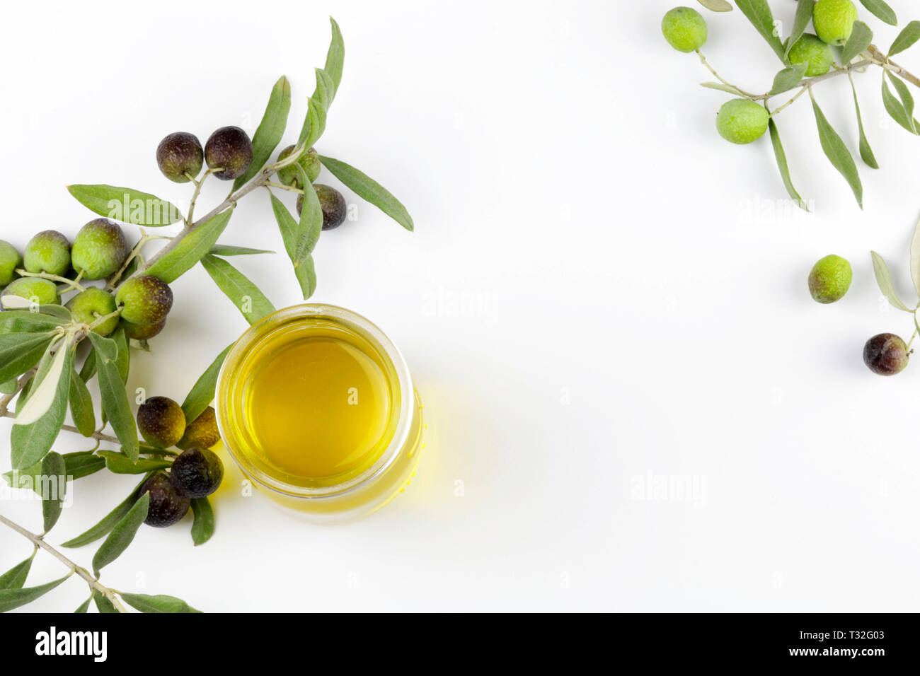 Fresh olives and olive oil on white background Stock Photo - Alamy