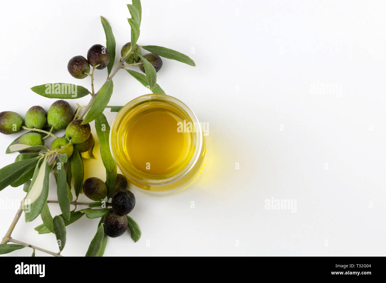 Fresh olives and olive oil on white background Stock Photo - Alamy
