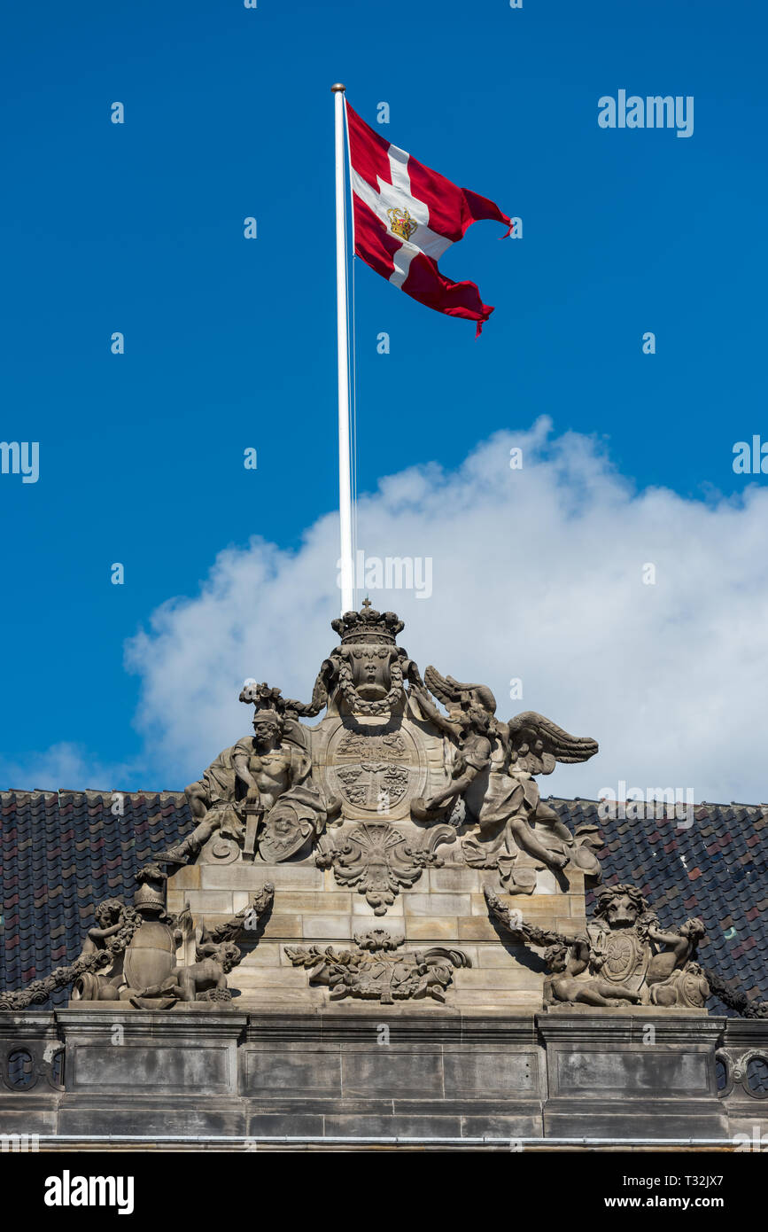 The Danish Royal Standard flies high above Christian VIII's Palace at Amalienborg Palace in Copenhagen Stock Photo