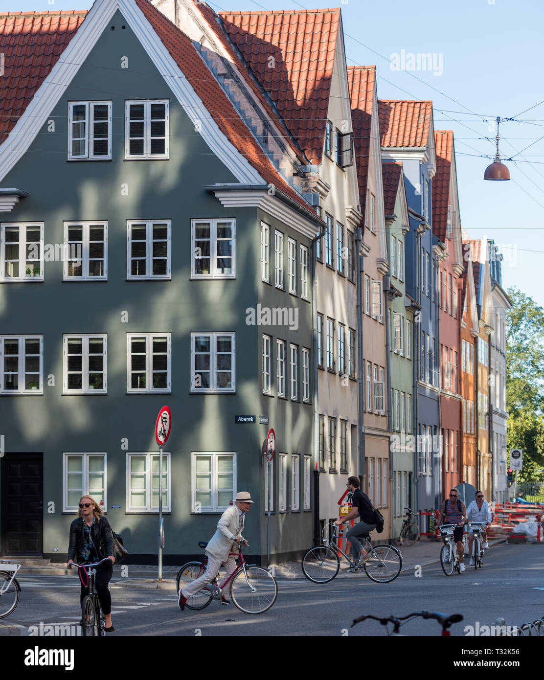 A dapper gentleman crossing Landemærket (landmark) on his bicycle. The colourful row of houses dates from the 1730's and No. 55 is listed. Stock Photo
