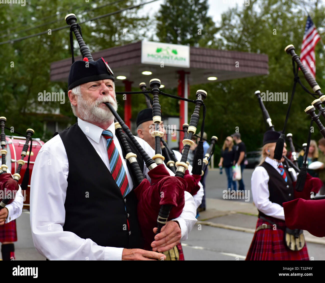 A bagpiper marching and playing in the 4th of July parade in Speculator, NY USA Stock Photo