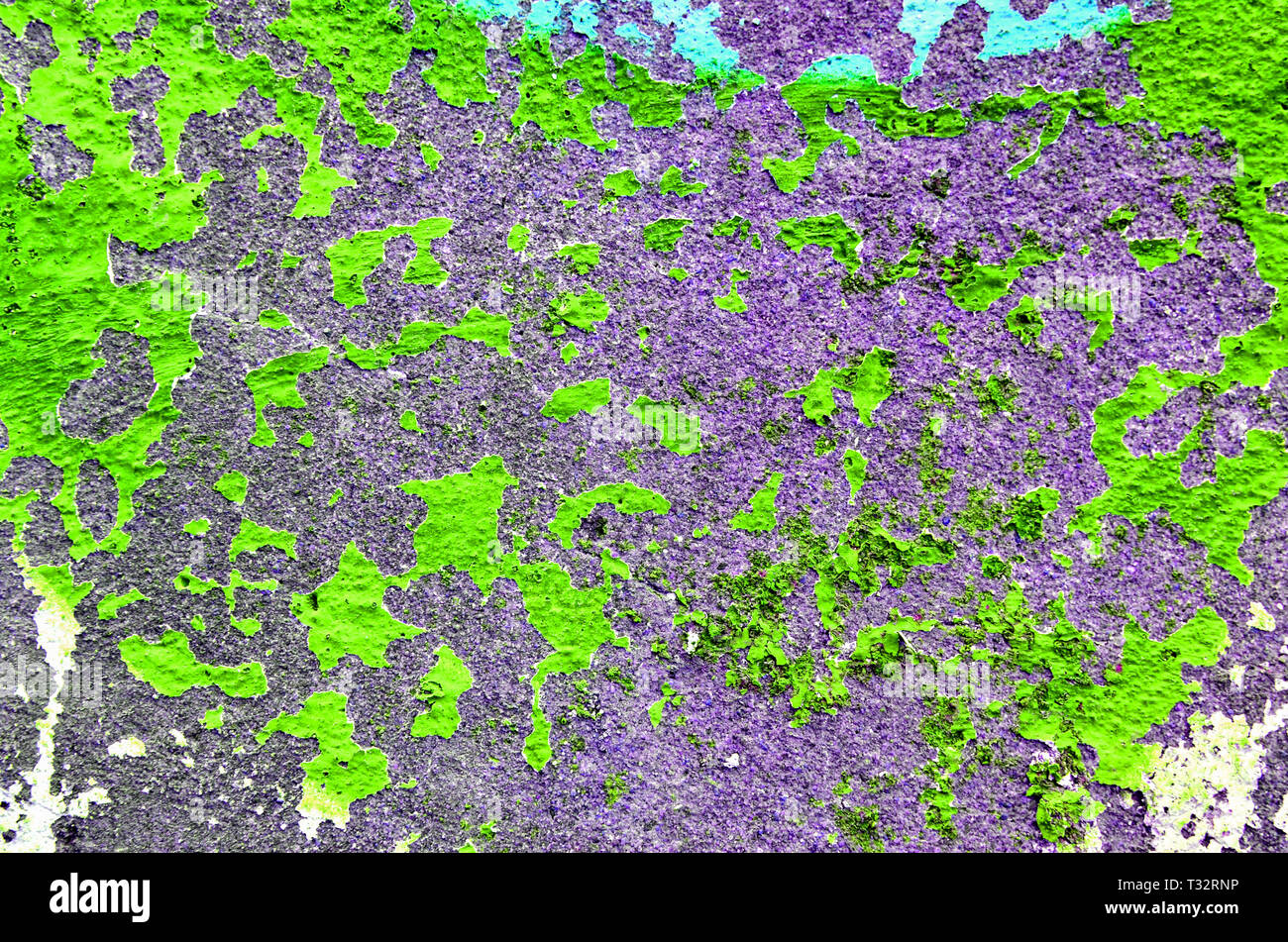 Old wall with peeling bright toxic green paint. Texture of bright green