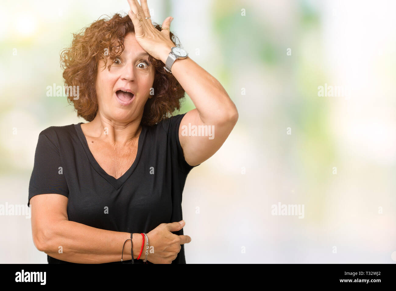 Beautiful middle ager senior woman over isolated background surprised ...