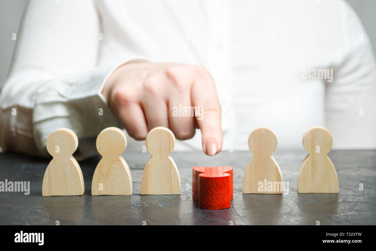 Woman leader dismisses the employee from the team. Female hand pushes a red man. Personnel Management. Bad worker. Demotion. Weak link. Team Managemen Stock Photo