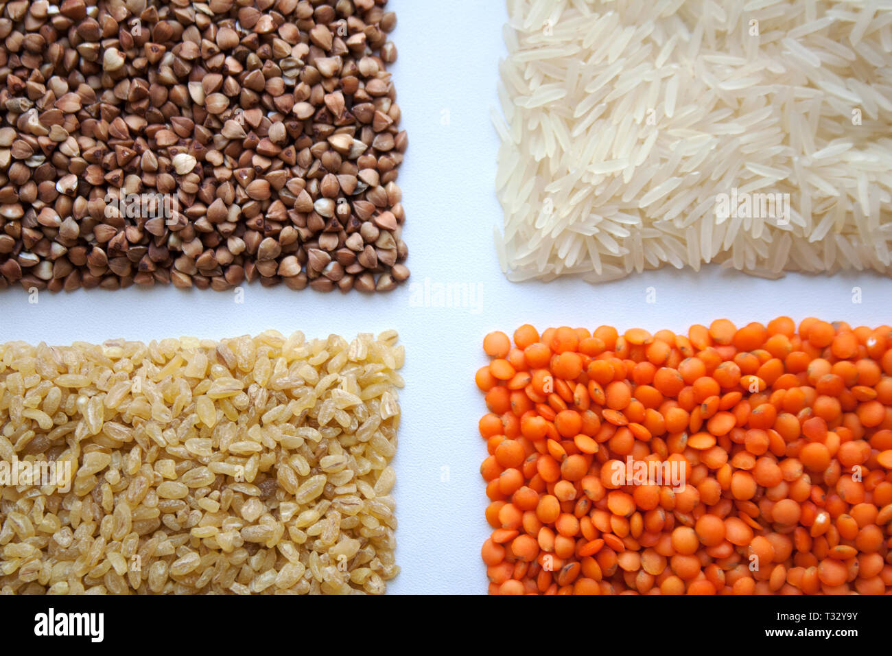 Raw buckwheat, basmati rice, bulgur and red lentils isolated on white ...