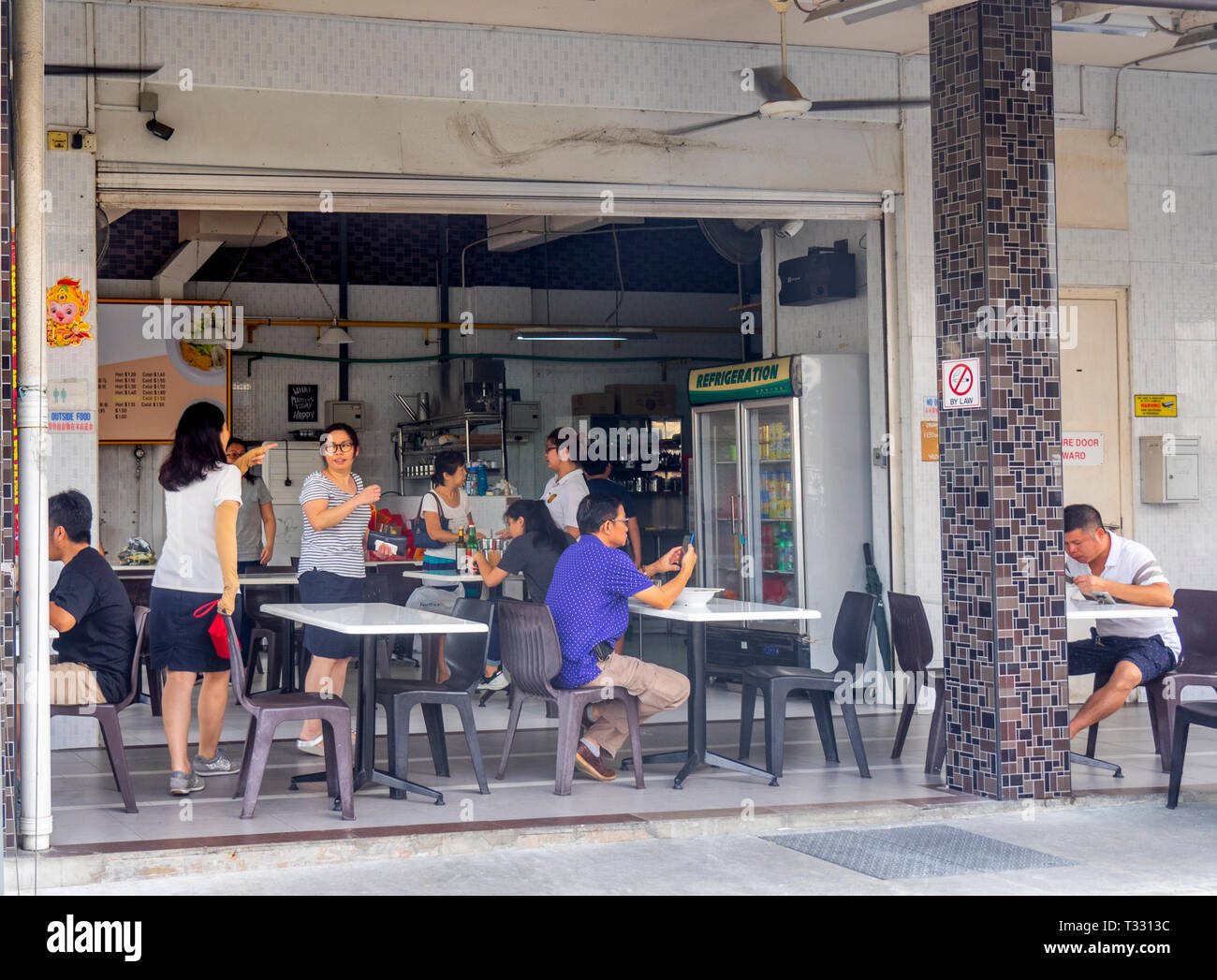 Locals eating at restaurant in Choo Chiat Singapore. Stock Photo