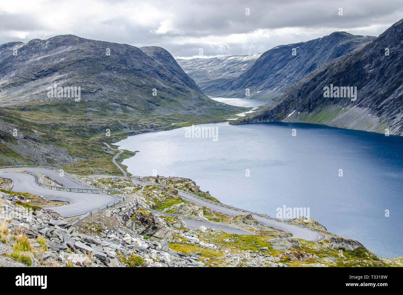 View of a lake and glacier valley from the road leading to the Dalsnibba viewpoint with mountains behind. Stock Photo