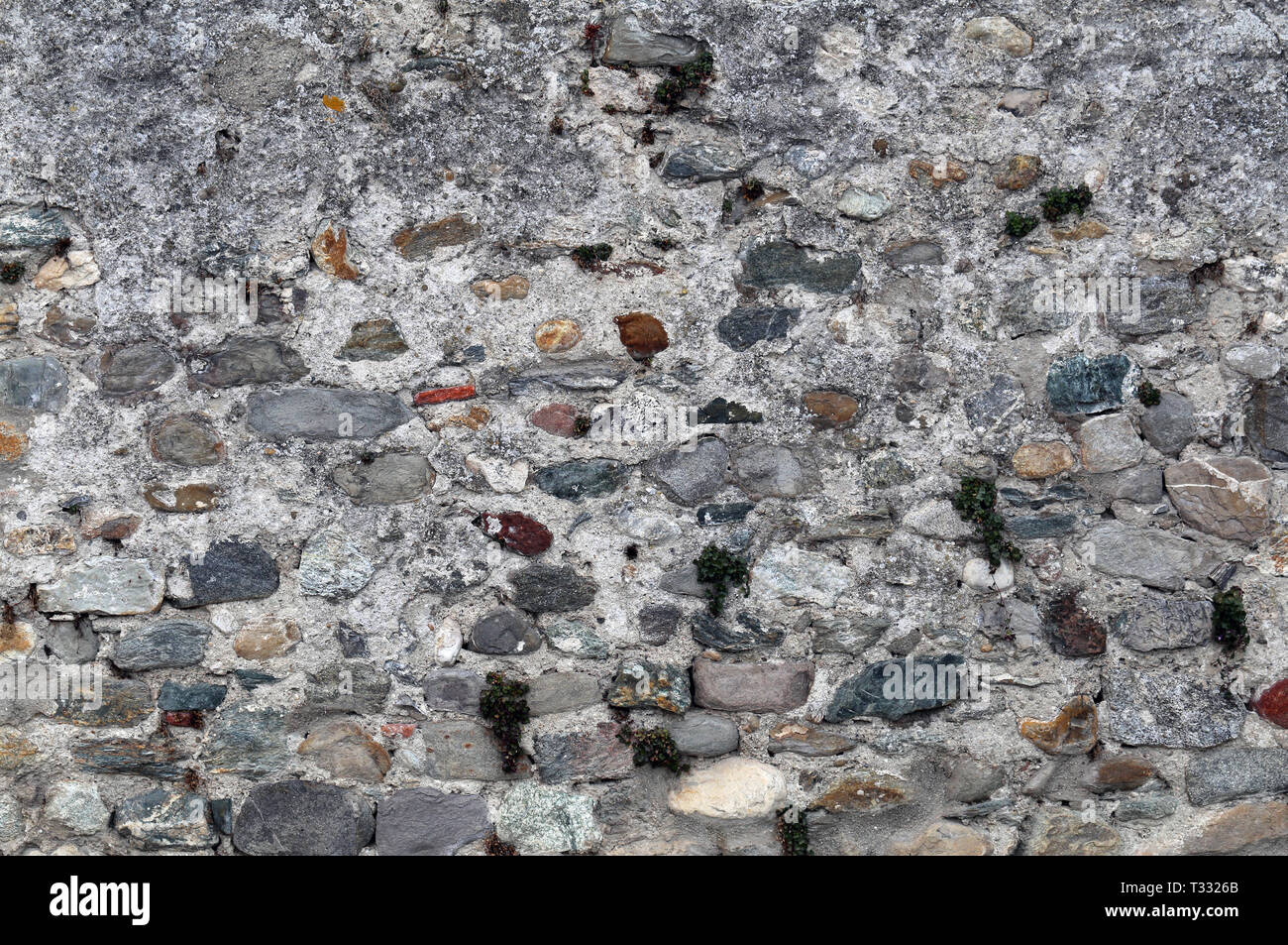 Medieval Rocks Color Paint Wall made of colorful rocks, tiles and concrete. Beautiful grey ...