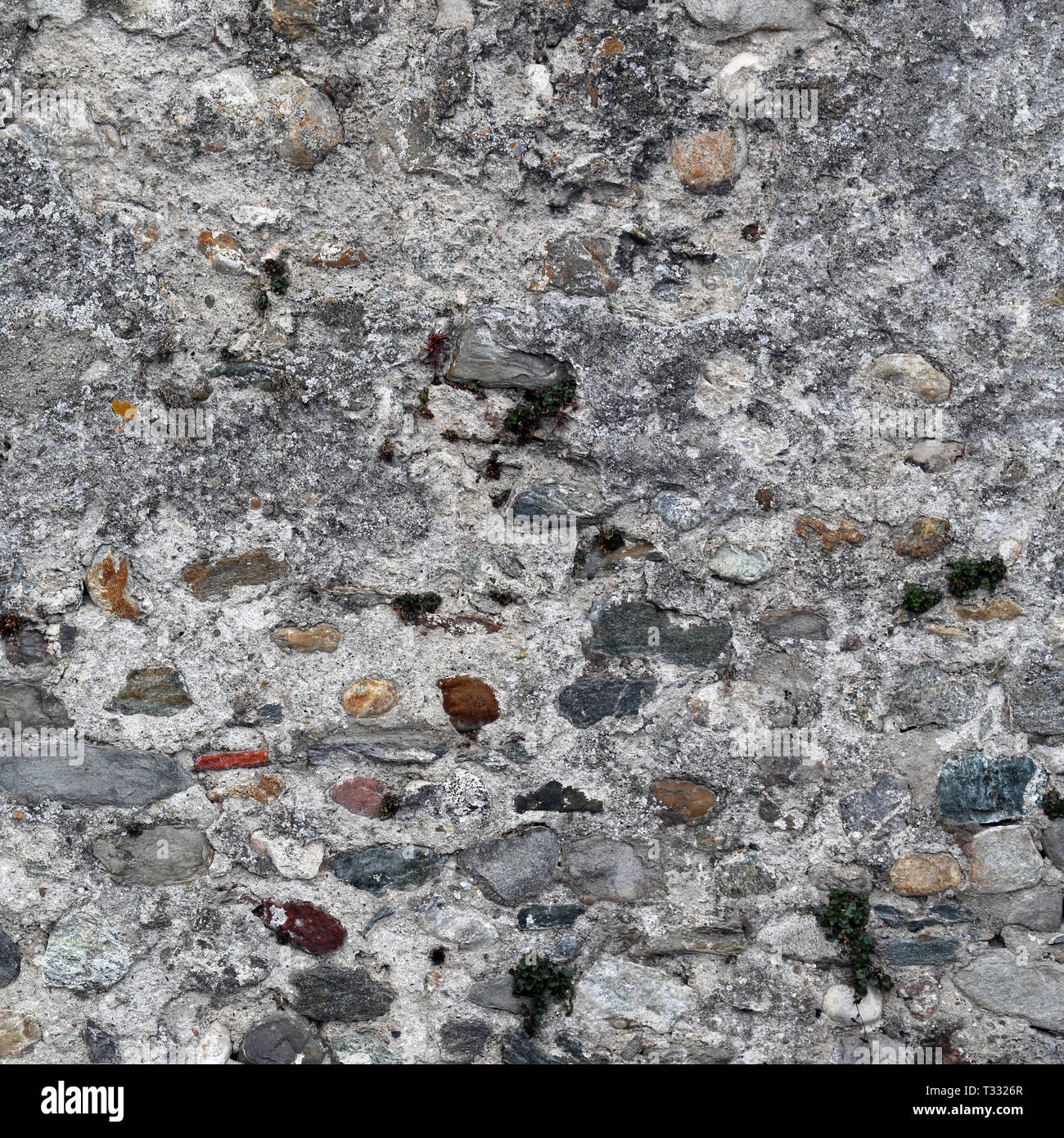 Medieval Rocks Color Wall made of colorful rocks, tiles and concrete. Beautiful grey ...