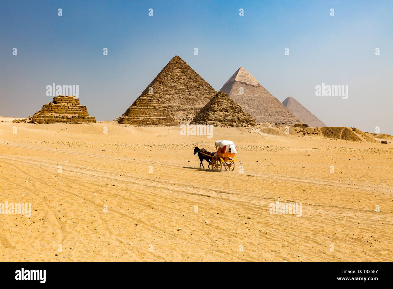 A Horse Carriage going to the Great Pyramids on the Giza Platea Stock Photo