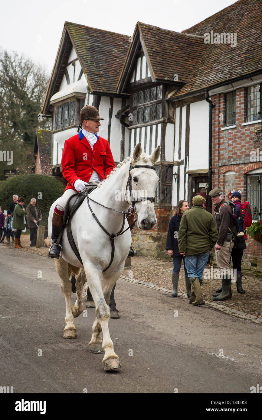 Hunstman of The Old Surrey Burstow and West Kent Hunt rides through Chiddingstone village for the traditional Boxing Day meet in Kent, UK Stock Photo