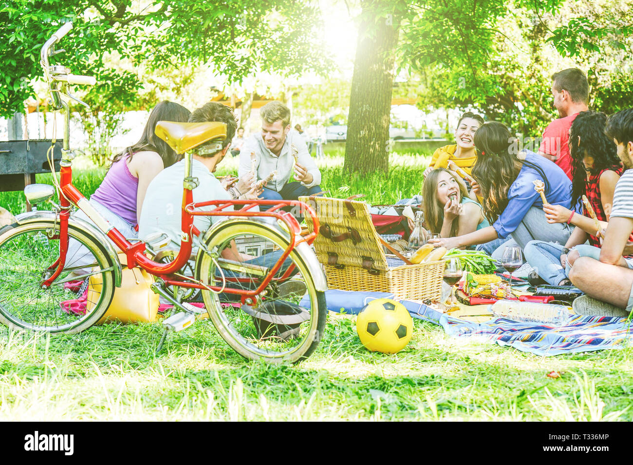 Group of a lot of people having a tasty picnic eating and drinking red