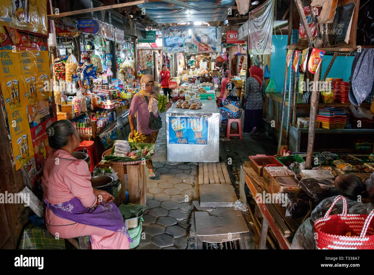 Undentified people in a local indoor market of Borobudur village with dark, small streets and numerous shops. Stock Photo