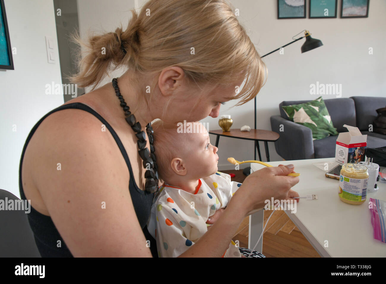 Mother feeding her 1 year old daughter Stock Photo