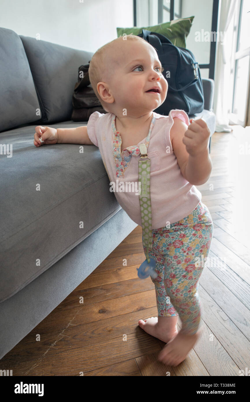 1 year old girl learning to walk Stock Photo
